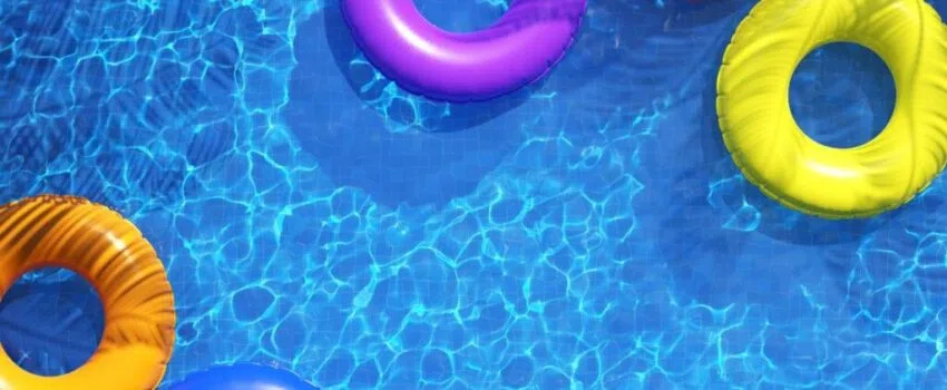 A swimming pool with colorful floaters.