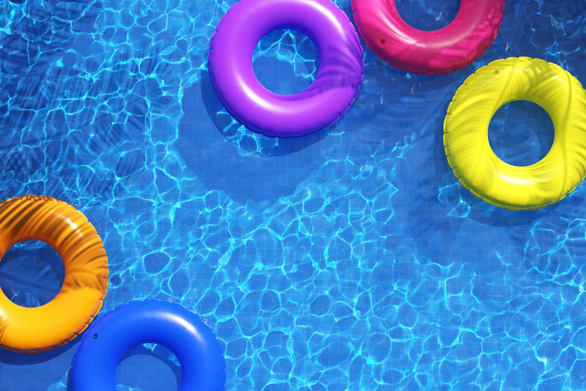 A swimming pool with colorful floaters.
