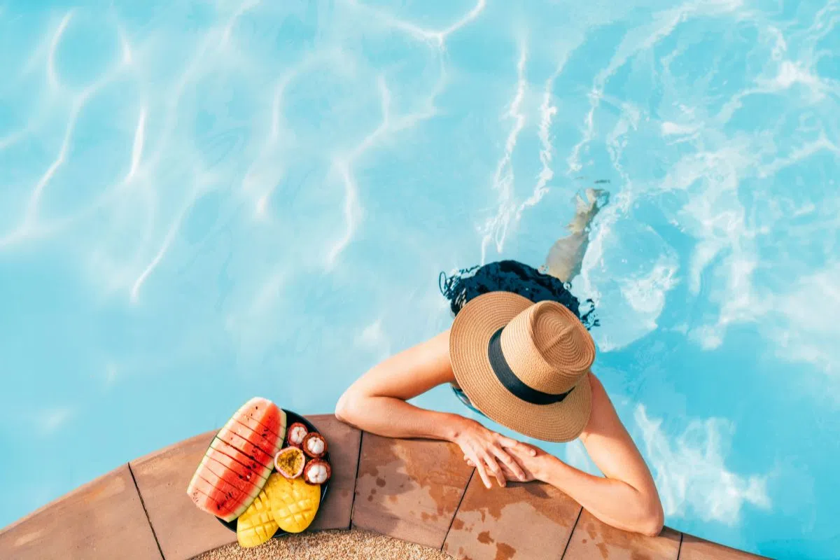 A woman lounging by the pool.