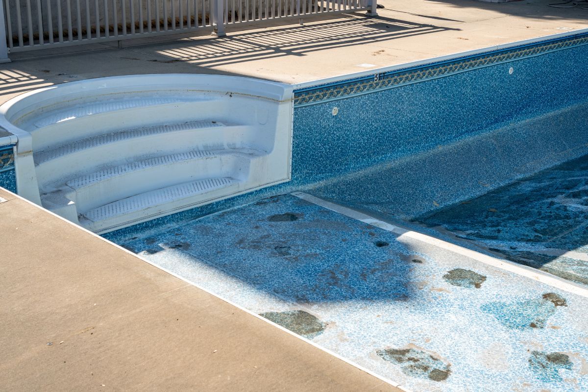 A pool with a lining in need of repair.