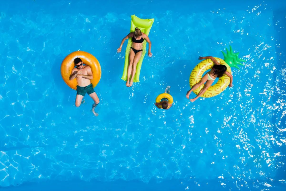 A family playing with floaters on the pool.