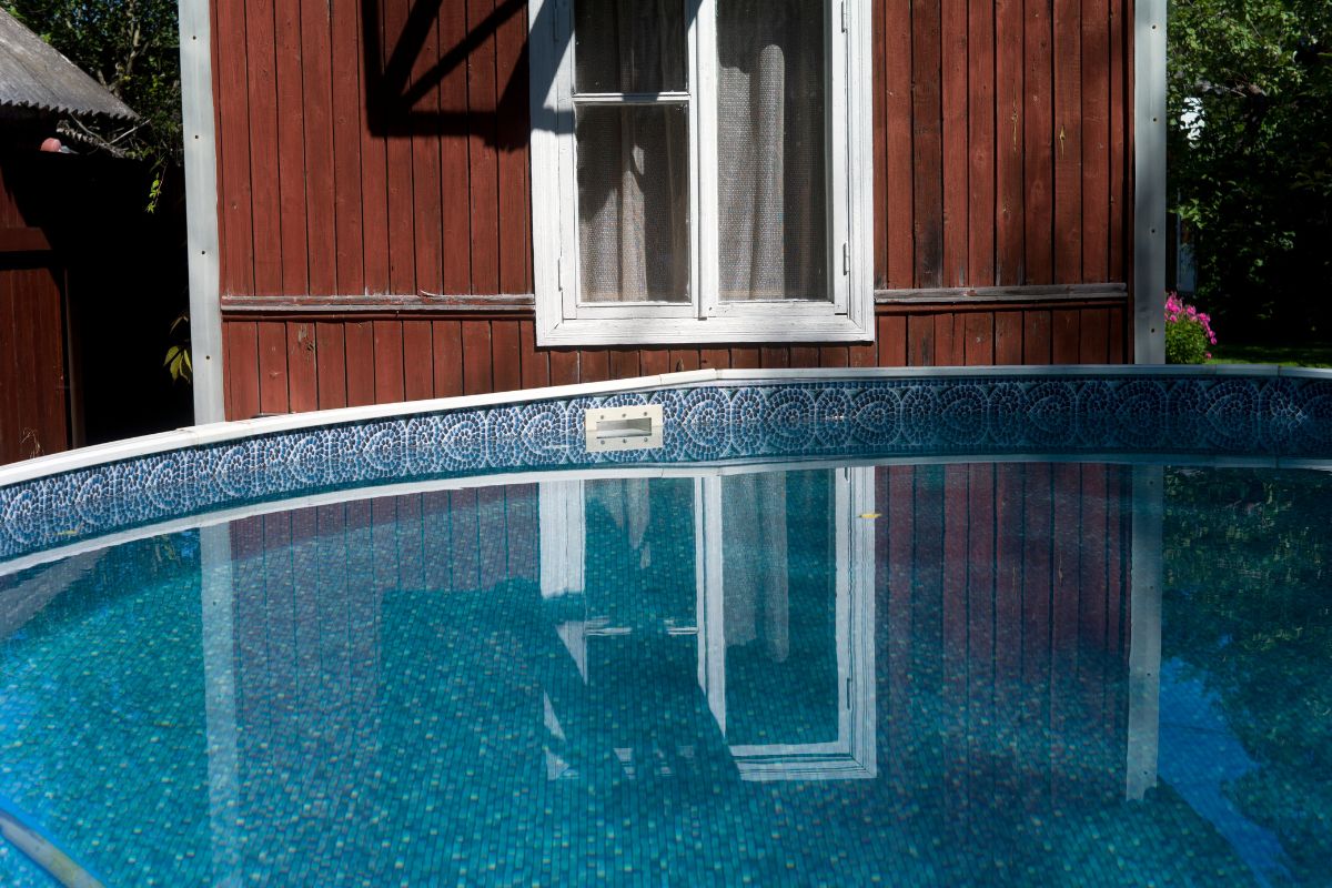 A small above ground pool in the yard of the house.