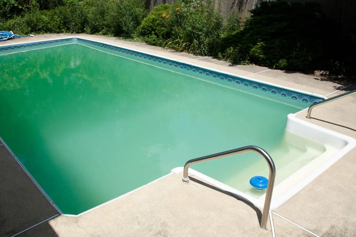 A pool with cloudy pool water.