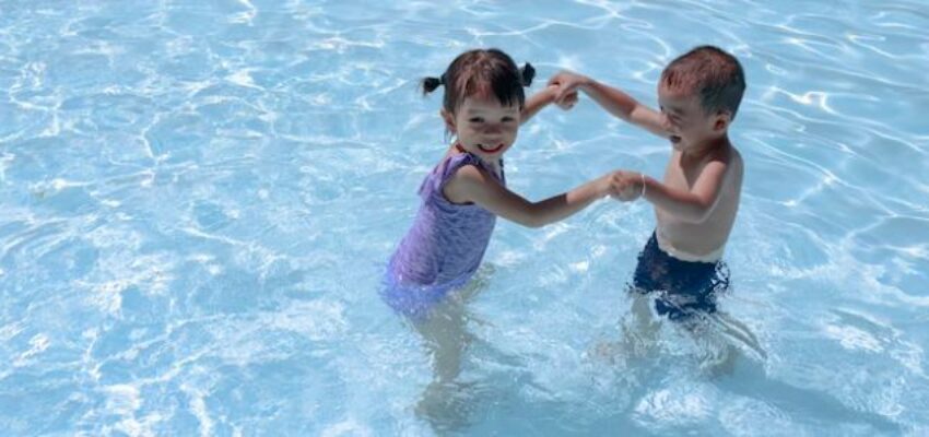 The siblings enjoy swimming at the pool that has a balance ph level of water.