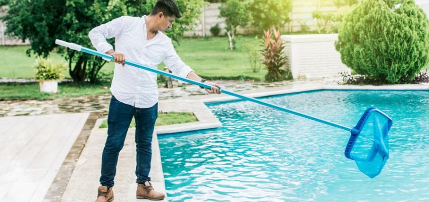 A man cleaning a pool.
