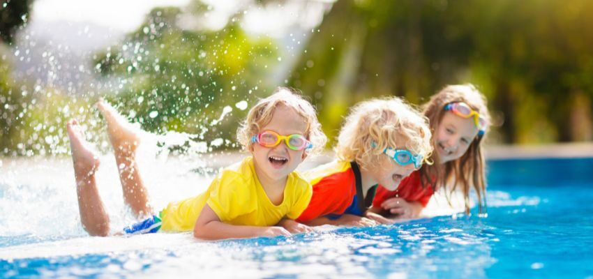 The children are happy while playing in a saltwater pool.