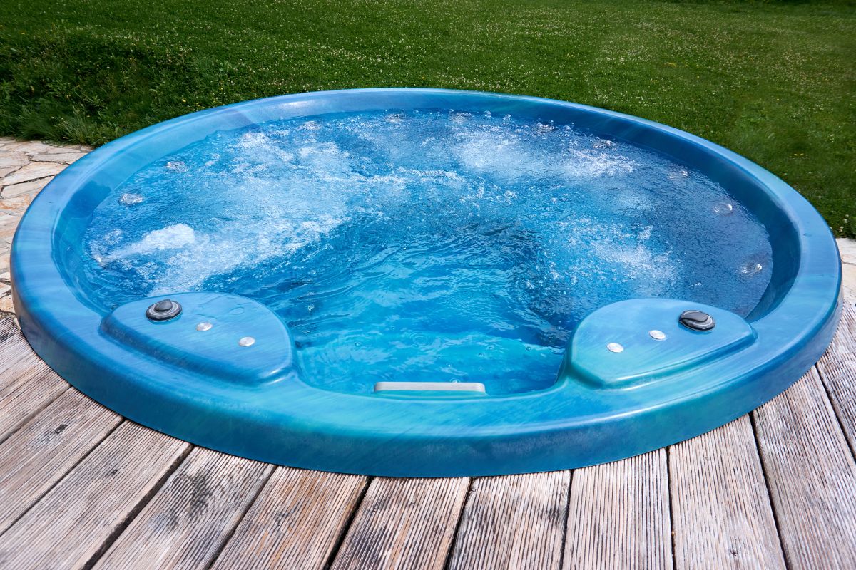 A hot tub with a deck surrounding it