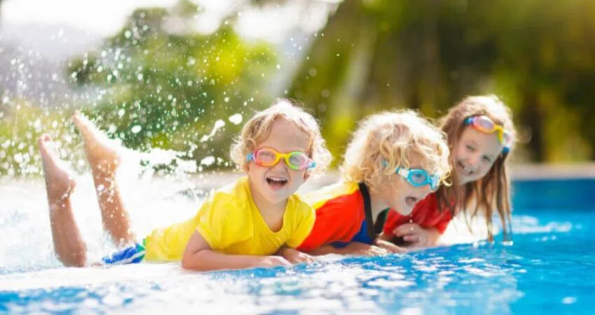 The kids are happy playing in the pool.