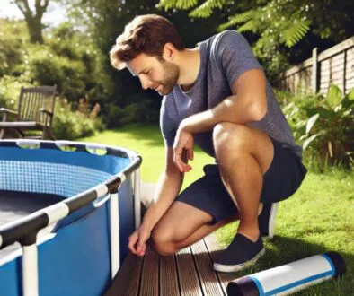 The man is searching for a leak in the above-ground pool.