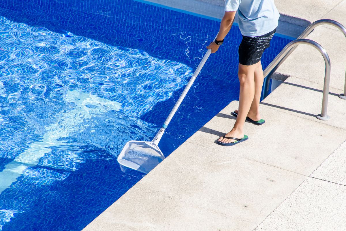 affordable-pool-care (1) The man is cleaning the pool.